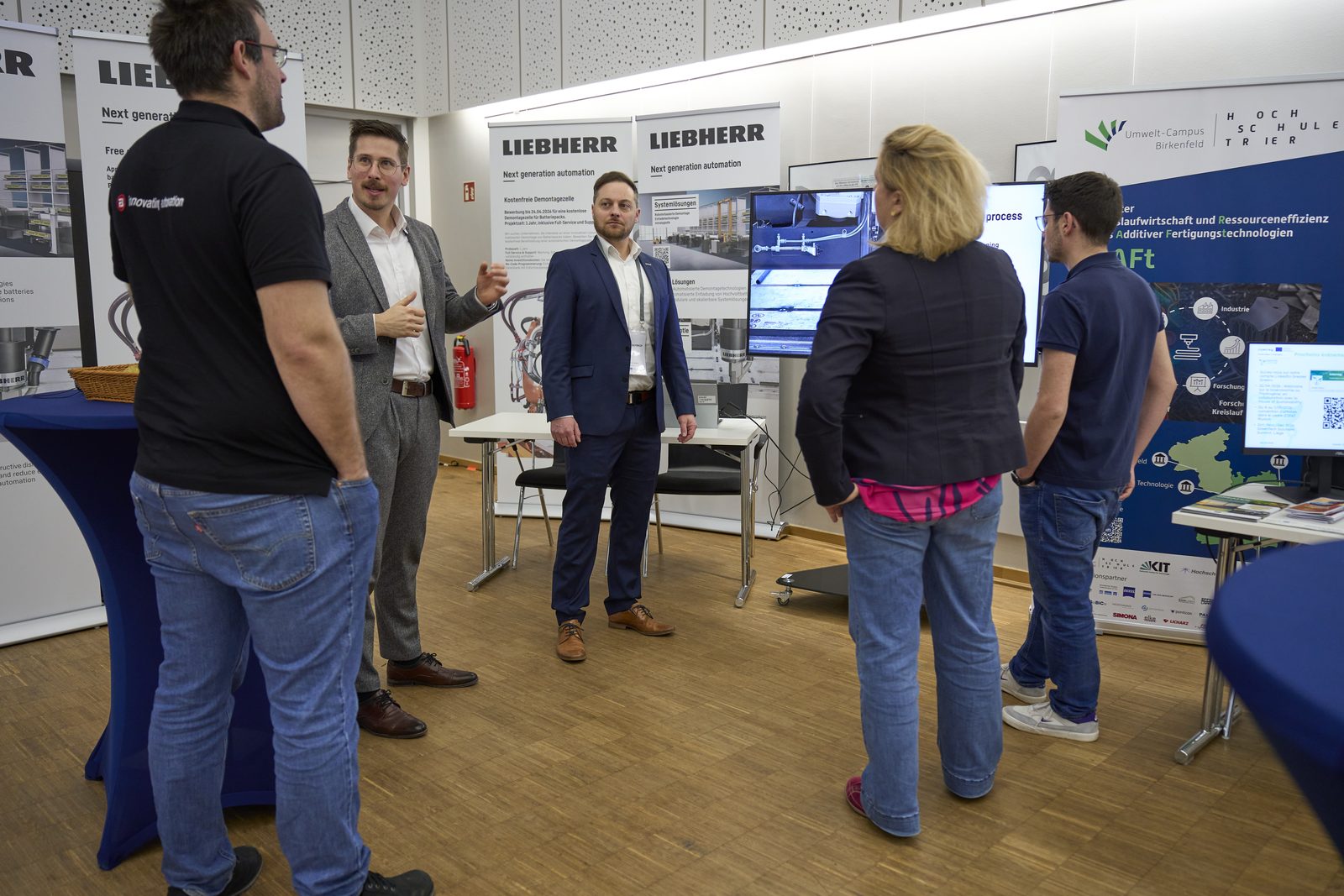 Visitors and exhibitors at the Liebherr stand.